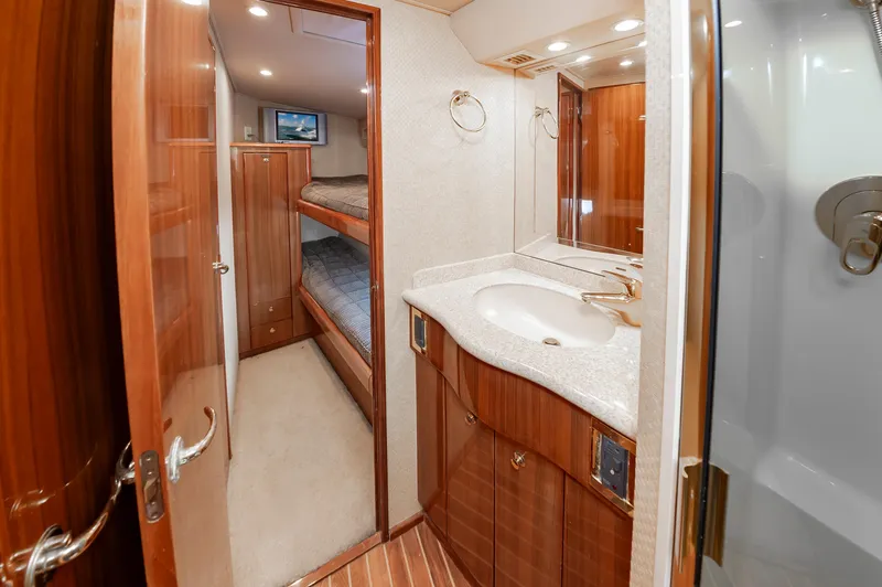 Slide: The Image of Luxurious 2005 Viking Convertible yacht interior with bathroom and bunk beds. - 48