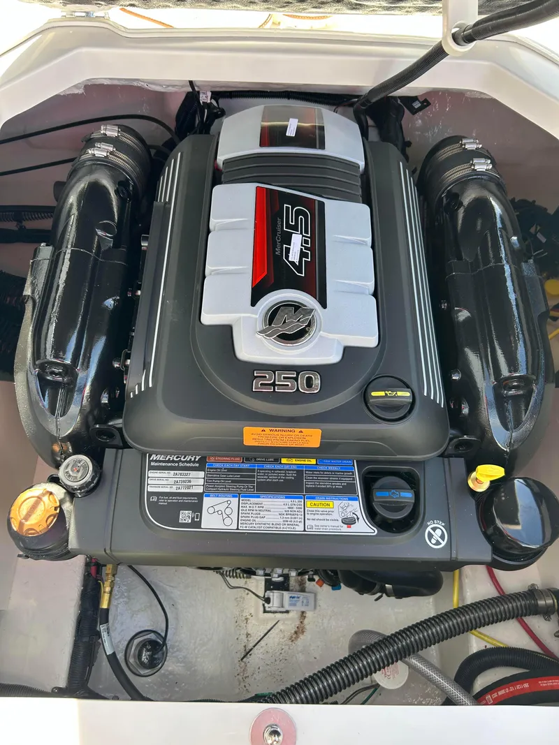 Slide: The Image of 2024 Chaparral 21 Ski & Fish boat engine compartment with 250 HP motor. - 2