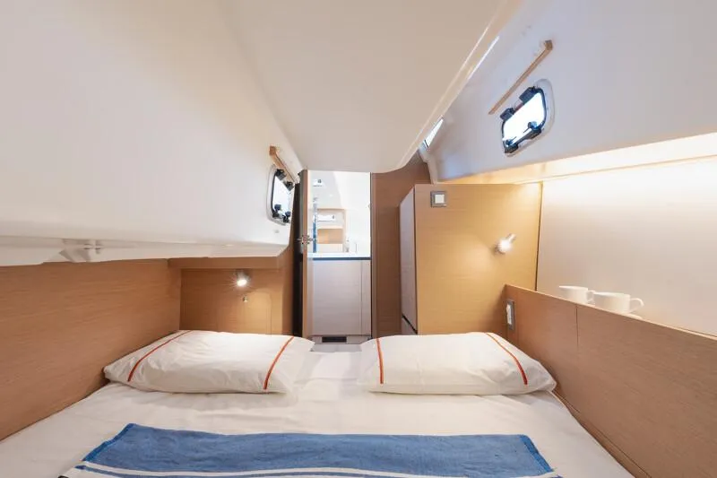 Slide: The Image of 2025 Jeanneau Sun Odyssey 350 cabin interior with cozy bed and modern design. - 15