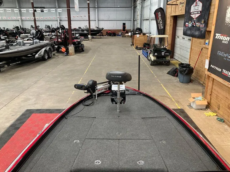 Slide: The Image of 2021 Nitro Z21 Pro bass boat in a showroom with other boats. - 7