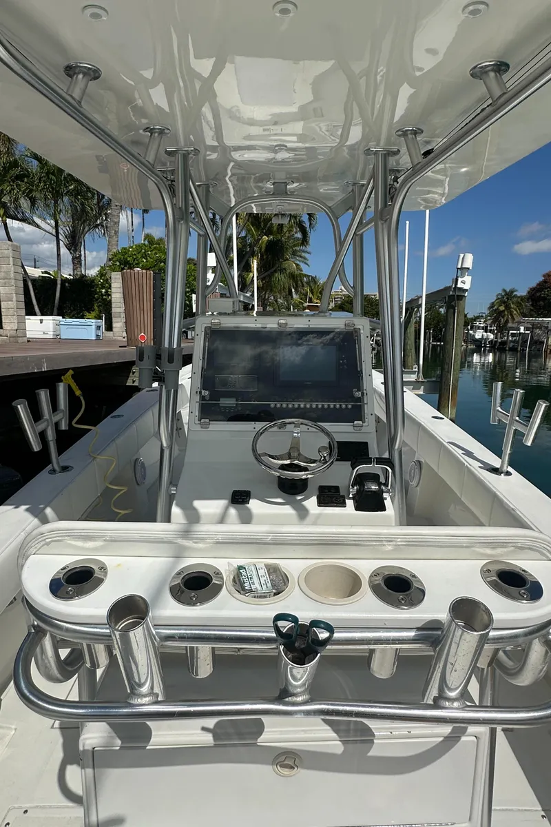 Slide: The Image of 1987 Whitewater 32 Open boat with center console and fishing rod holders. - 15