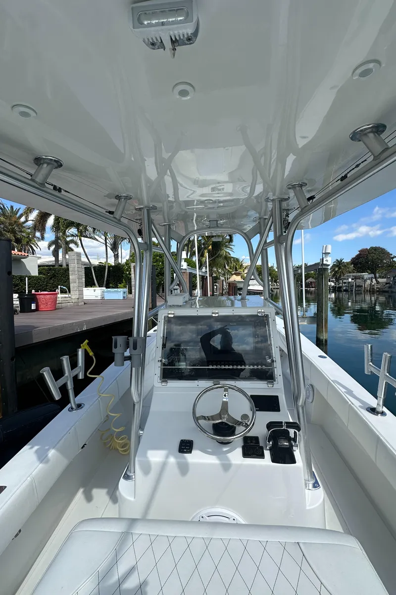 Slide: The Image of 1987 Whitewater 32 Open boat interior with steering console and waterfront view. - 16