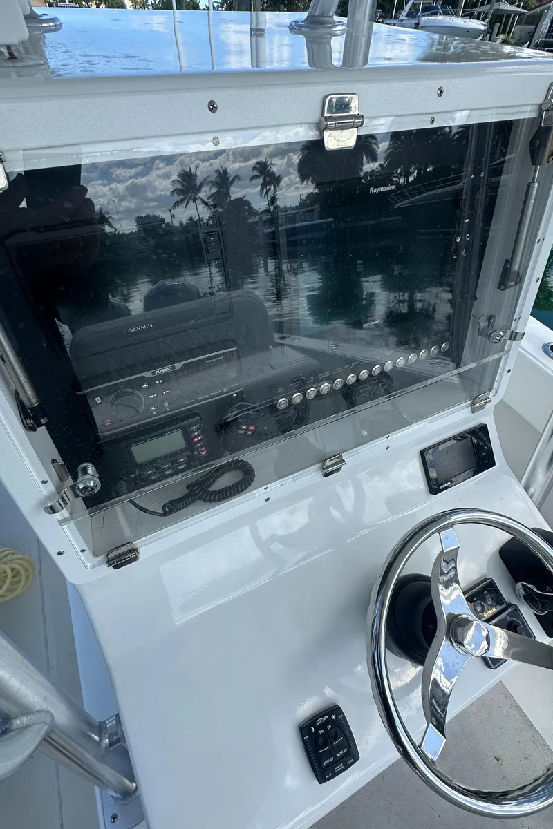 Slide: The Image of 1987 Whitewater 32 Open boat console with steering wheel and control panel. - 17
