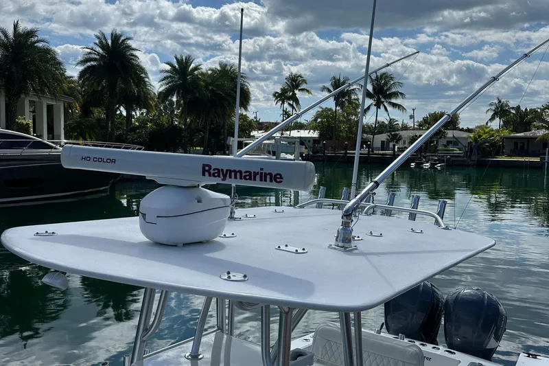Slide: The Image of 1987 Whitewater 32 Open boat with Raymarine radar, docked in a tropical marina. - 18
