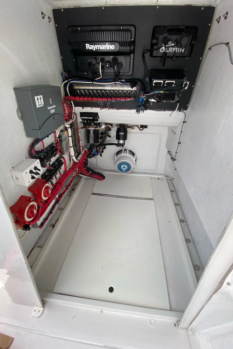 Slide: The Image of 1987 Whitewater 32 Open boat electronics compartment with Raymarine and Garmin systems. - 19