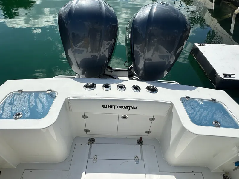 Slide: The Image of 1987 Whitewater 32 Open boat with twin outboard engines. - 2