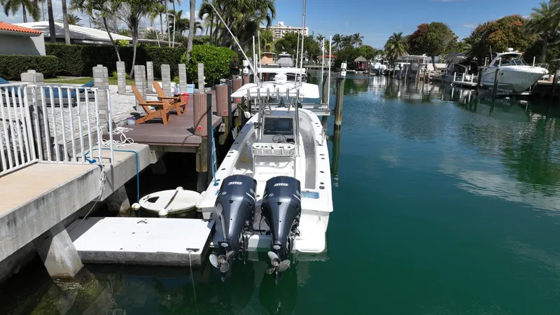 Slide: The Image of 1987 Whitewater 32 Open boat docked in a serene canal. - 3
