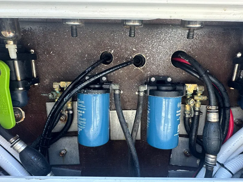 Slide: The Image of 1987 Whitewater 32 Open boat engine compartment with fuel filters and hoses. - 5