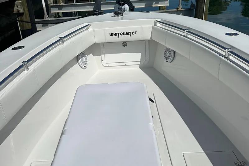 Slide: The Image of 1987 Whitewater 32 Open boat interior with white seating and storage compartments. - 8