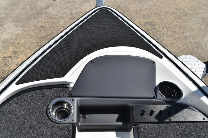 Slide: The Image of 2024 Triton 179 TrX boat deck with cup holder and control panel. - 10