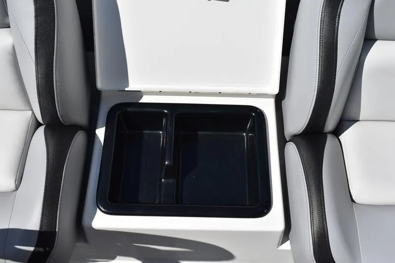 Slide: The Image of 2024 Triton 179 TrX boat seat storage compartment, open with black interior. - 15