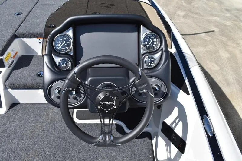 Slide: The Image of 2024 Triton 179 TrX boat dashboard with steering wheel and gauges. - 16