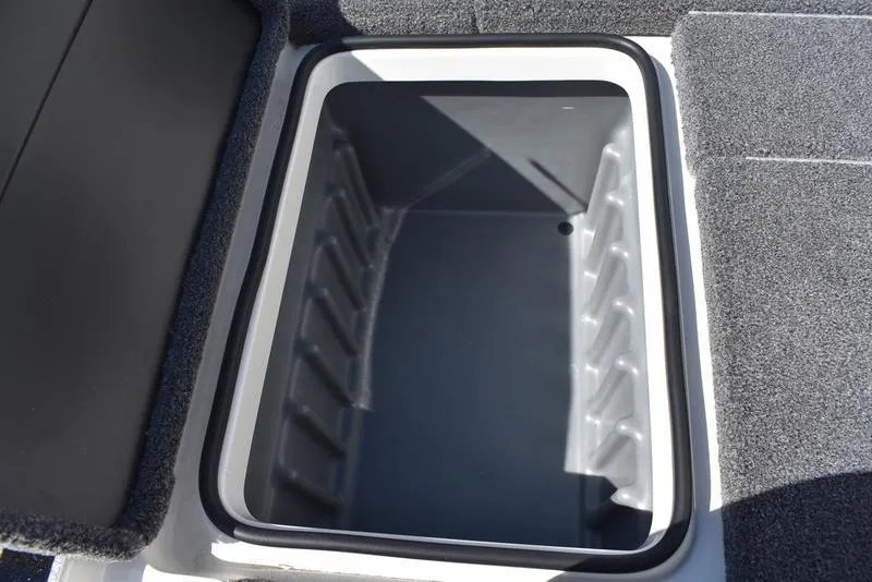 Slide: The Image of Storage compartment of 2024 Triton 179 TrX boat, featuring a spacious, carpeted interior. - 19