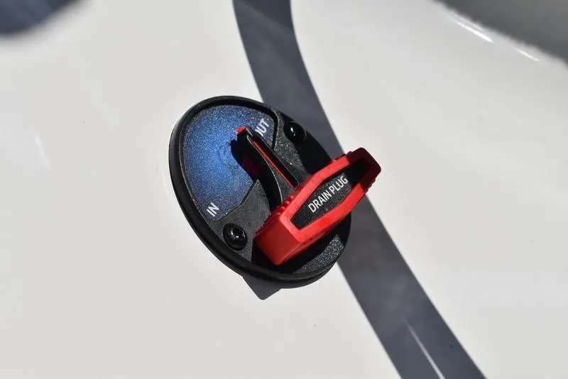 Slide: The Image of 2024 Triton 179 TrX drain plug with red handle on white surface. - 24