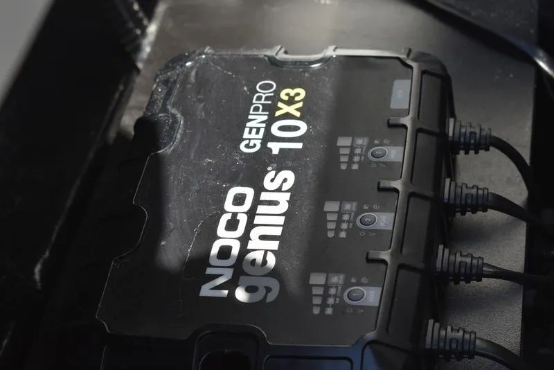 Slide: The Image of NOCO Genius GENPRO 10X3 charger in a 2024 Triton 179 TrX boat. - 28