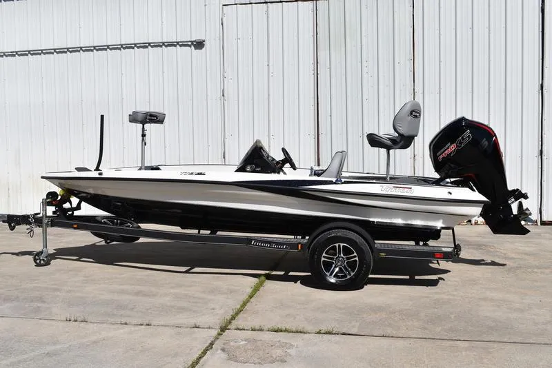 Slide: The Image of 2024 Triton 179 TrX boat on trailer, parked outdoors. - 3