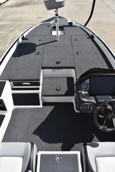 Slide: The Image of 2024 Triton 179 TrX boat interior with steering console and seating area. - 9