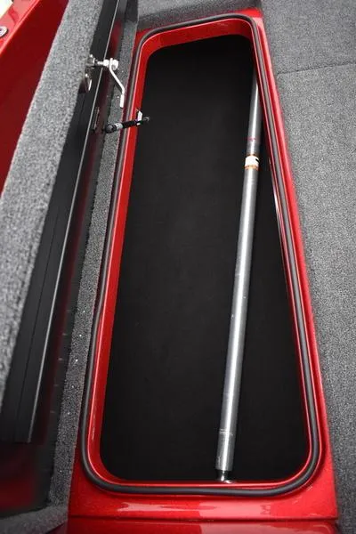 Slide: The Image of 2024 Triton 206 Allure storage compartment with a fishing rod. - 13
