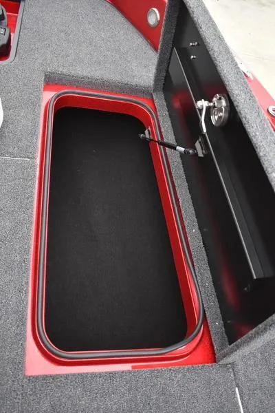 Slide: The Image of 2024 Triton 206 Allure storage compartment with red trim and black interior. - 15