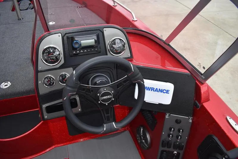 Slide: The Image of 2024 Triton 206 Allure boat dashboard with steering wheel and control panel. - 20
