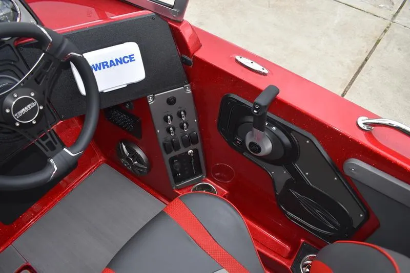 Slide: The Image of 2024 Triton 206 Allure boat interior, featuring steering wheel, control panel, and red accents. - 21