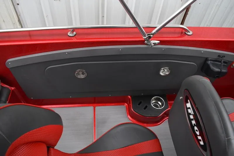 Slide: The Image of 2024 Triton 206 Allure boat interior with red and black seating. - 28