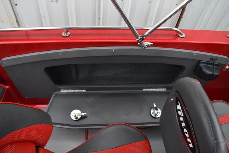 Slide: The Image of 2024 Triton 206 Allure boat interior with storage compartment and seating. - 29