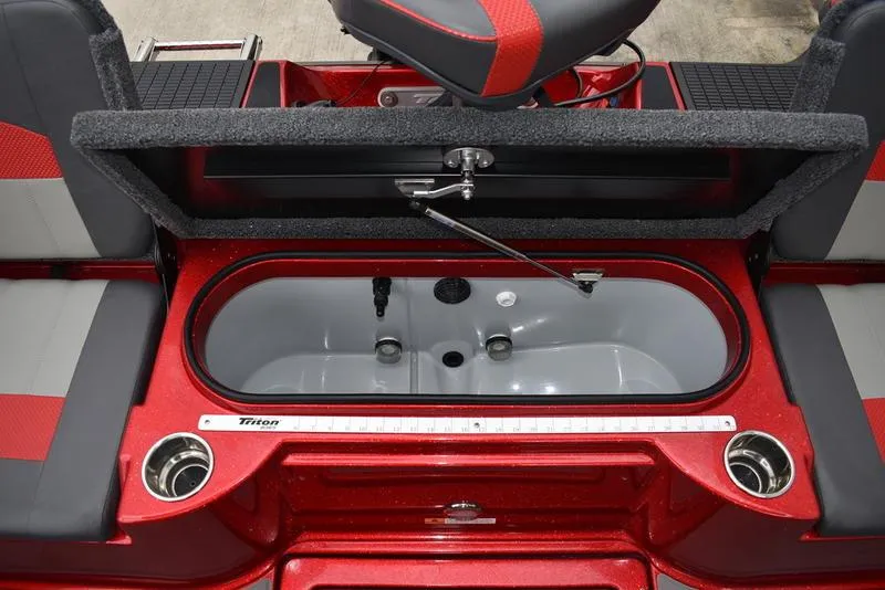 Slide: The Image of 2024 Triton 206 Allure boat interior with open storage compartment and seating. - 33