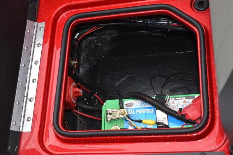 Slide: The Image of Battery compartment of 2024 Triton 206 Allure boat with wiring and connections. - 34