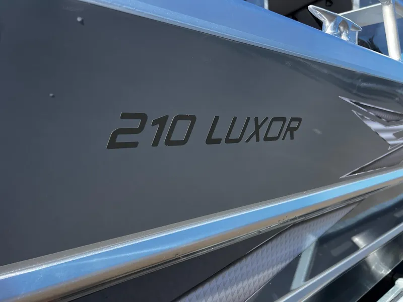 Slide: The Image of 2024 Thunder Jet 210 Luxor boat side view with model name displayed. - 10