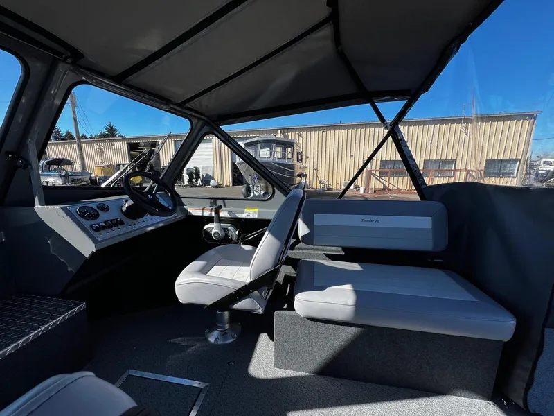 Slide: The Image of 2024 Thunder Jet 210 Luxor boat interior with seating and control panel. - 12