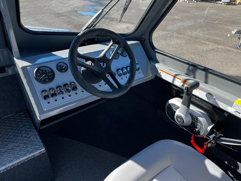 Slide: The Image of 2024 Thunder Jet 210 Luxor boat cockpit with steering wheel and control panel. - 13