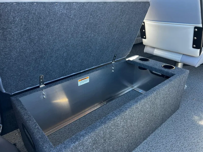 Slide: The Image of 2024 Thunder Jet 210 Luxor storage compartment with cup holders. - 17