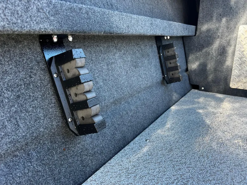 Slide: The Image of 2024 Thunder Jet 210 Luxor interior with rod holders and carpeted flooring. - 22