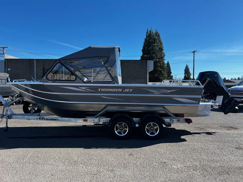 Slide: The Image of 2024 Thunder Jet 210 Luxor boat on a trailer in a parking lot. - 4