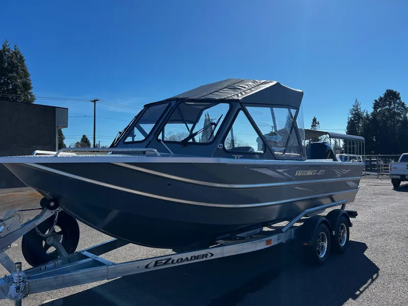 Slide: The Image of 2024 Thunder Jet 210 Luxor boat on EZ Loader trailer in outdoor setting. - 5