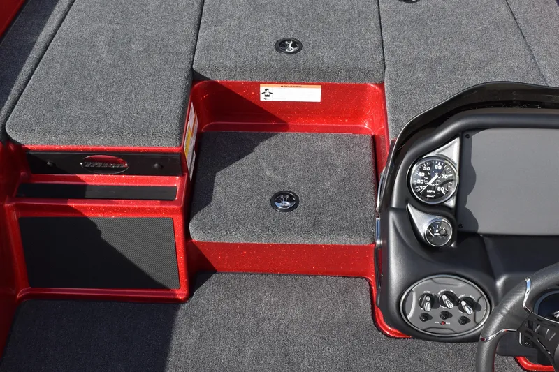Slide: The Image of 2024 Triton 179 TrX boat interior with red accents and dashboard controls. - 12