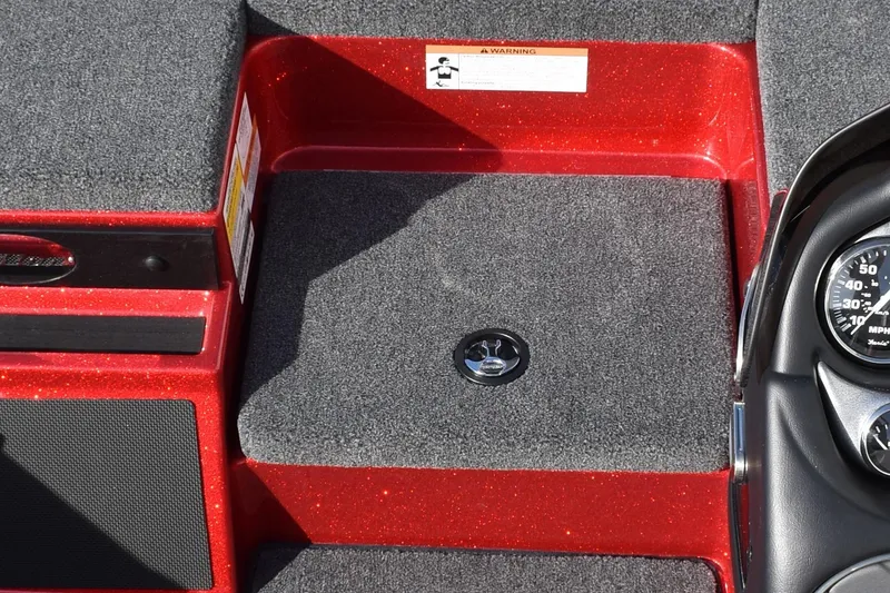 Slide: The Image of 2024 Triton 179 TrX boat interior with red accents and carpeted flooring. - 18