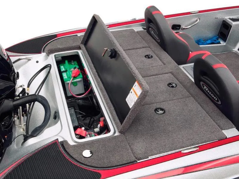 Slide: The Image of 2024 Triton 179 TrX boat interior with open storage compartment and seating. - 27