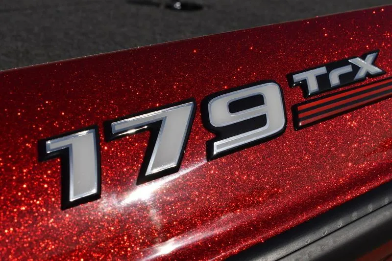 Slide: The Image of Close-up of 2024 Triton 179 TrX logo on sparkling red surface. - 5
