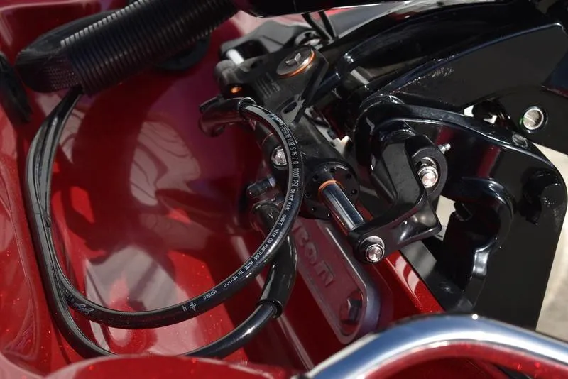 Slide: The Image of Close-up of 2024 Triton 179 TrX boat components, featuring hydraulic cables and red interior. - 7