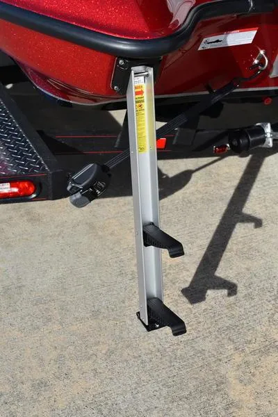 Slide: The Image of 2024 Triton 179 TrX boat trailer step ladder on concrete surface. - 9