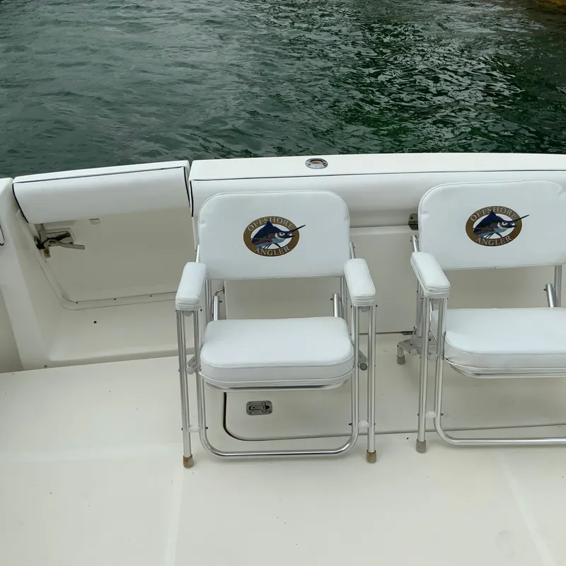 Slide: The Image of Two white fishing chairs on a 2000 Tiara Sport 35 Open boat. - 11