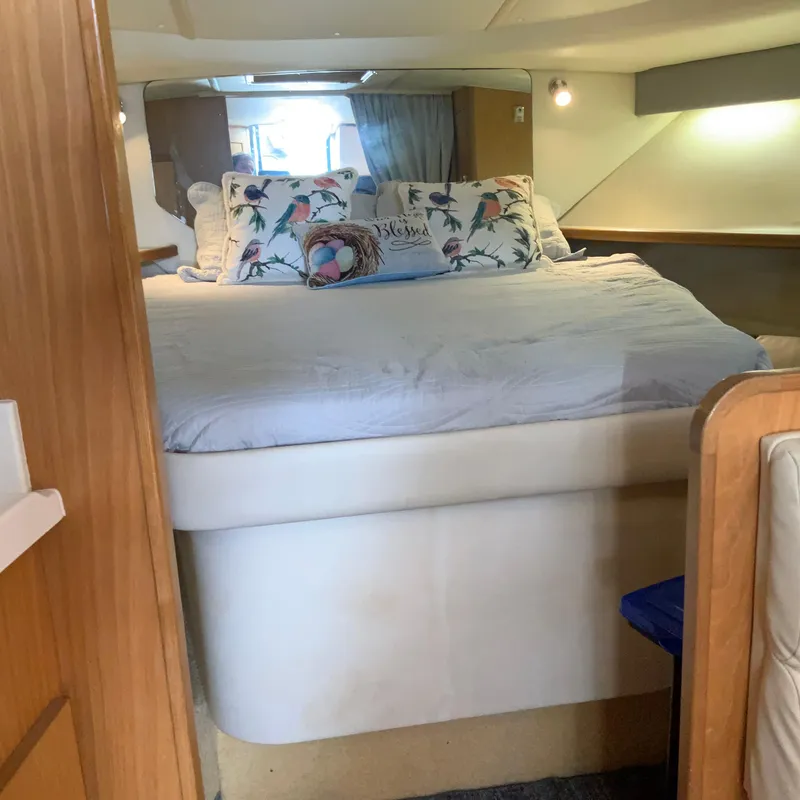 Slide: The Image of Cozy bedroom in a 2000 Tiara Sport 35 Open yacht with floral pillows. - 16