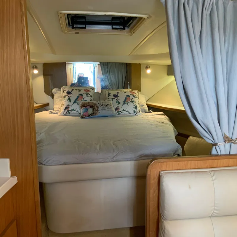 Slide: The Image of Cozy bedroom interior of a 2000 Tiara Sport 35 Open boat with floral pillows. - 22