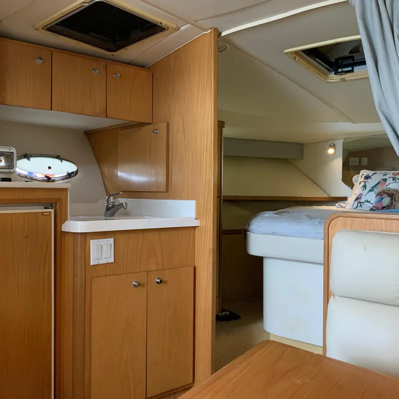 Slide: The Image of Interior of a 2000 Tiara Sport 35 Open boat with a small kitchenette and bed. - 24