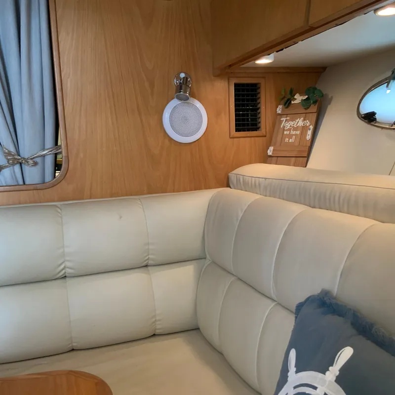 Slide: The Image of Interior of a 2000 Tiara Sport 35 Open boat with beige seating and wooden accents. - 25