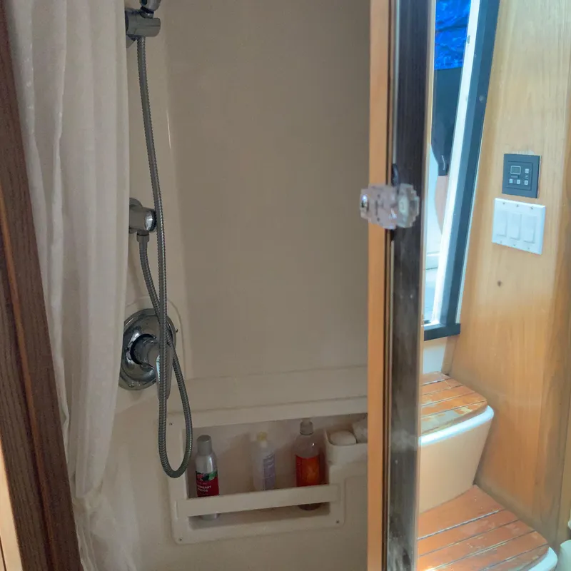 Slide: The Image of Shower area in 2000 Tiara Sport 35 Open boat with toiletries and wooden seat. - 27