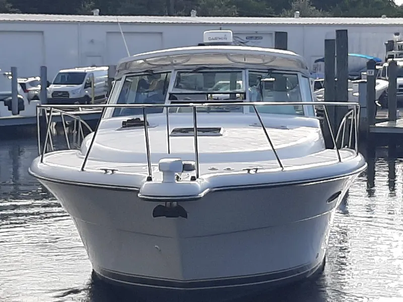 Slide: The Image of Front view of a 2000 Tiara Sport 35 Open boat docked in a marina. - 3