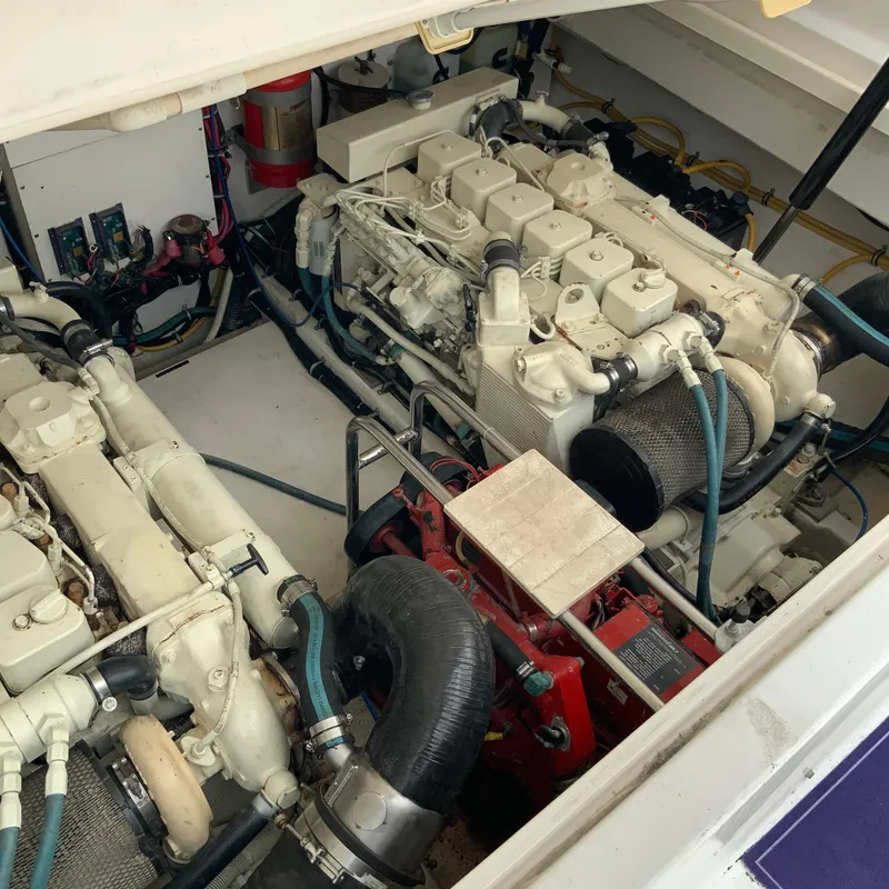 Slide: The Image of Engine compartment of a 2000 Tiara Sport 35 Open boat, showcasing twin engines. - 36